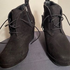 Black Wedges with zipper on the zip and laces. Size 7 very minimal wear.
